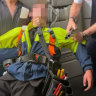  A youth is subdued aboard the Jetstar plane. 