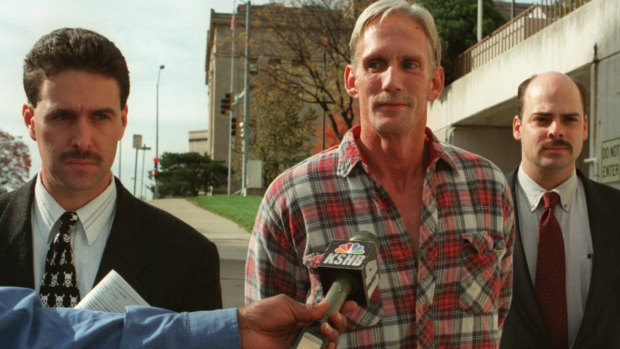 Wesley Purkey pictured in 1998 at his arrest for the rape and murder of a 16-year-old girl.
