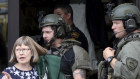 Law enforcement officers help evacuate the neighbourhood after the shooting in the Chicago suburb of Highland Park.