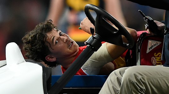 Wil Powell is carried from the field.