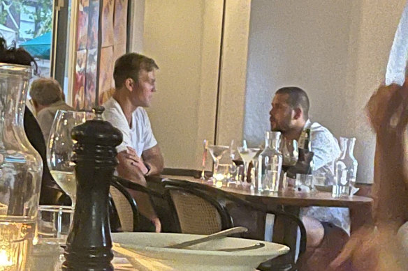 Buddy Franklin (right) at the dinner with an unidentified man.