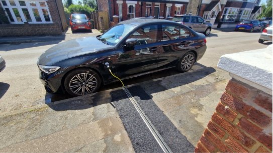 A pilot scheme in Central Bedfordshire Council in England allows electric vehicle owners to charge their cars on the street outside their homes with a charging cable embedded into the pavement.