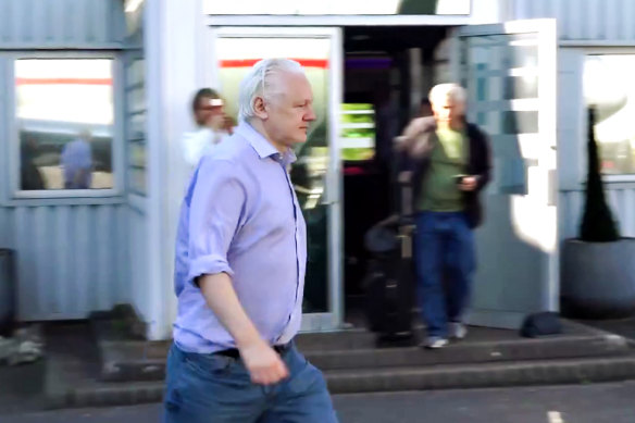Julian Assange boards a flight at London Stansted Airport on Monday, London time. 
