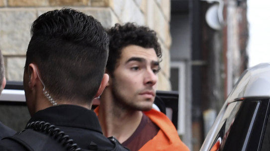 Luigi Nicholas Mangione is escorted into Blair County Courthouse in Hollidaysburg, Pennsylvania.