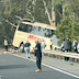 Footage shared to Facebook shows the bus teetering off an embankment after it crashed through traffic barriers on the highway.