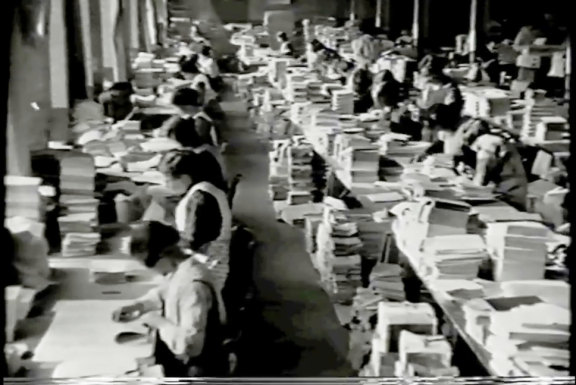 A still from the 1925 film Oxford University Press and the Making of a Book showing women at work in the bindery.