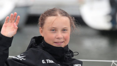 Greta Thunberg waves to her supporters on her arrival in New York aboard the zero-emissions yacht Malizia II on Wednesday. 