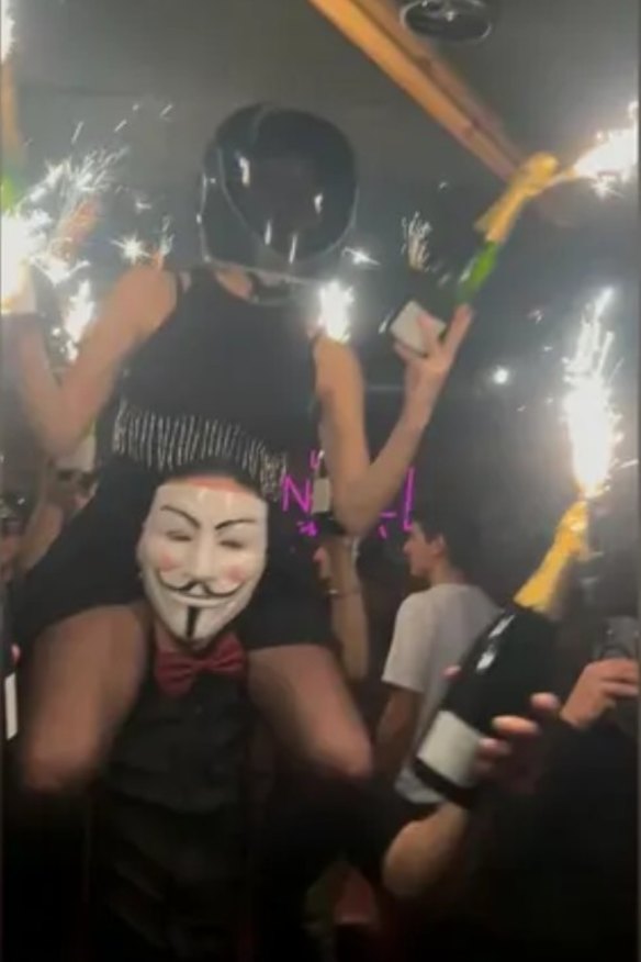 In a photograph of the bar reportedly taken by a survivor before the fire broke out and sent to France’s BFMTV, a woman can be seen on the shoulders of a man, holding bottles in her hands with sparklers attached.