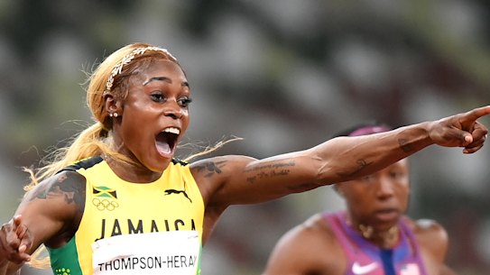 Elaine Thompson-Herah celebrates her gold.