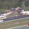 Man trapped after truck tips off Bruce Highway