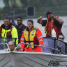 Locals in fishing boats help with rescue efforts in Lismore.