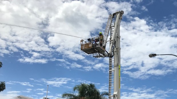 Aerial attack: A firefighter in a cherry picker assists with the operation.