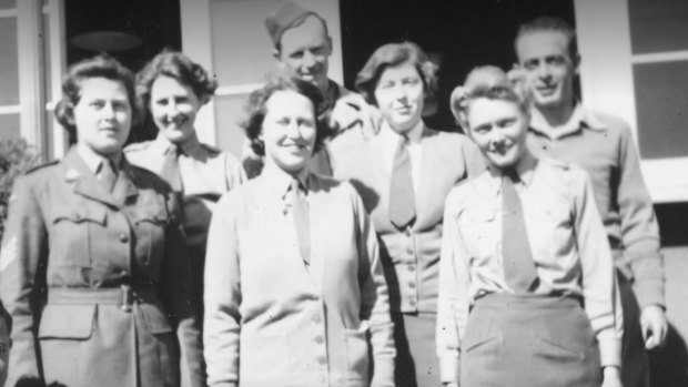 A group of Garage Girls and male military colleagues during World War II.