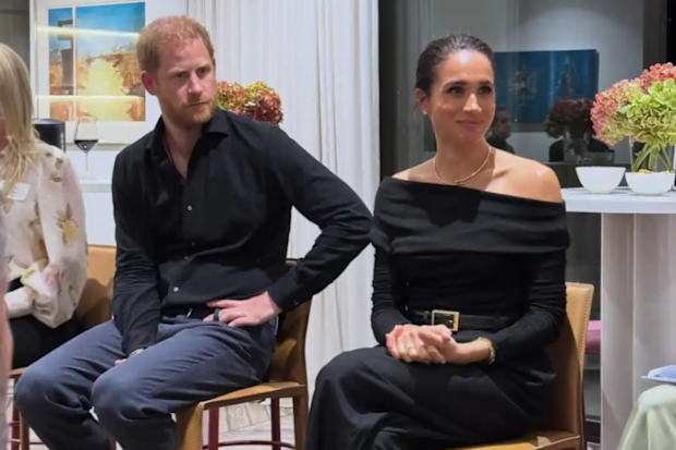 Meghan Markle and Prince Harry sitting side by side 