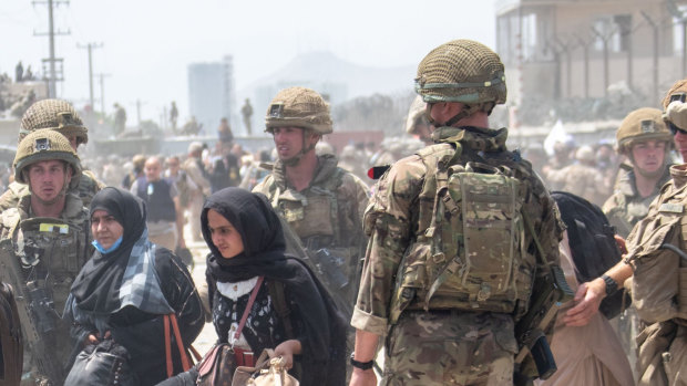 British troops try to help evacuate some Afghans amid chaotic scenes outside the airport in Kabul.