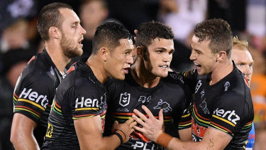 Practice makes perfect: Nathan Cleary celebrates with teammates after converting a try to force the match against the Tigers to golden point.
