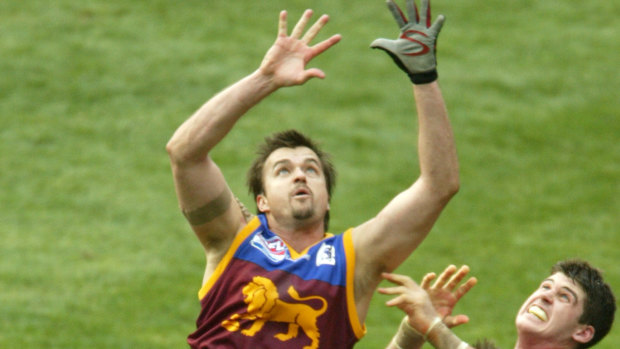 Clark Keating (L) flies for a mark in the 2004 grand final. 