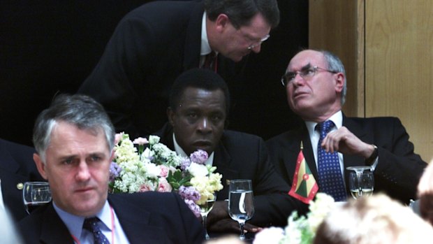 Lynton Crosby speaks with John Howard at a luncheon in Washington in 2002.