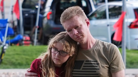 Christopher Bradford, right, and daughter Neriah Bradford pay their respects at a memorial for Charlie Kirk at Utah Valley University on Friday.