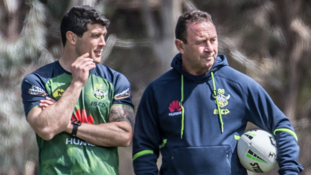 Odd couple: Michael Ennis with Ricky Stuart at a Canberra training session.