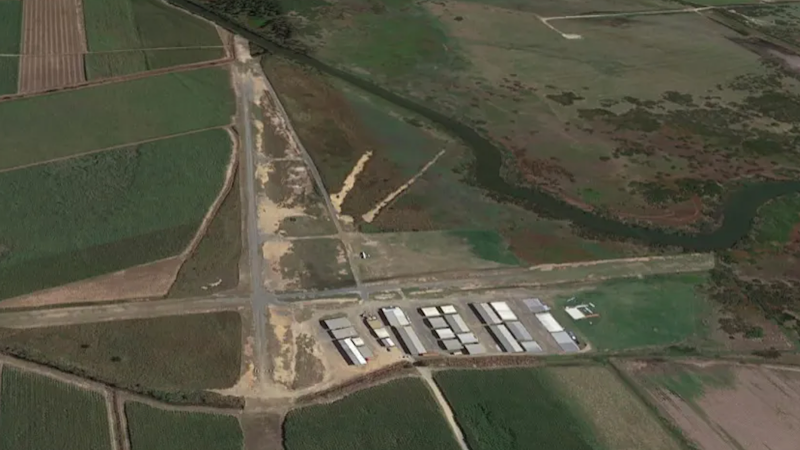 Plane crash-lands, two people trapped in cockpit as field burns