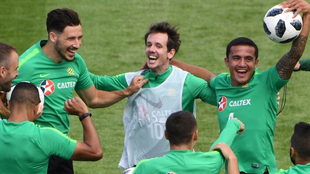 One of the boys: Robbie Kruse (white vest) and the Socceroos ham it up at the World Cup.