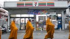 Buddhist monks collect alms in Bangkok  during the pandemic.
