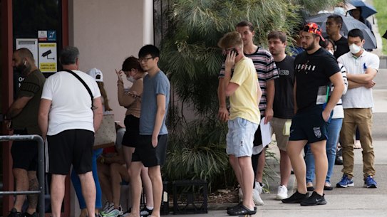 People queue outside a Centrelink office in Sydney. In April alone, more than 221,000 people lost their jobs in NSW.