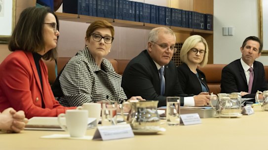 L-R: Minister for Government Services and Minister for the NDIS Linda Reynolds, Minister for Families and Social Services and Minister for Women's Safety Anne Ruston, Minister for Foreign Affairs Marise Payne, Prime Minister Scott Morrison, Assistant Minister to the Attorney-General and Assistant Minister for Women Amanda Stoker, Minister for Finance Simon Birmingham and Minister for Defence Industry Melissa Price during the cabinet women's taskforce meeting at Parliament House in Canberra on  Tuesday 6 April 2021. fedpol Photo: Alex Ellinghausen