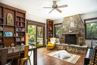 The living area features a stone-walled fireplace.