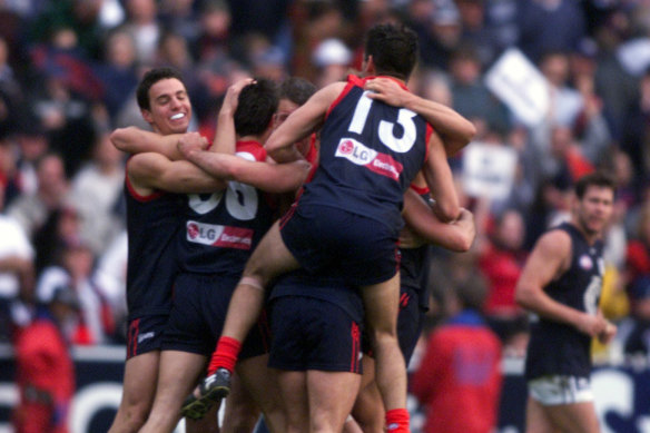 The Demons celebrate their win after the final siren.