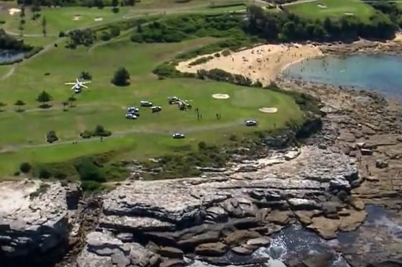 A man and child have died after being swept away from rocks while fishing at Little Bay. 