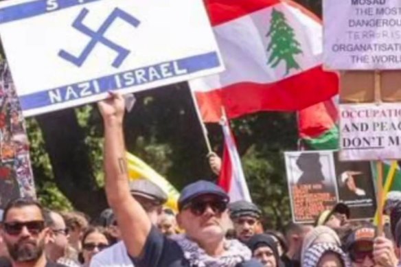 A man, allegedly Alan Yazbek, with the offensive sign at the pro-Palestine rally in Sydney on Sunday.