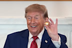 President Donald Trump holds a solid gold replica of a deep sea nodule he was gifted during a roundtable on American mining on Friday.