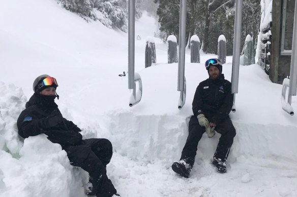 Resort staff at a snowed-in ski lift at Mount Buller after heavy falls over the past week. 