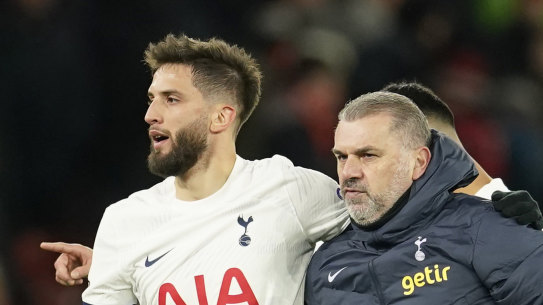 Tottenham’s head coach Ange Postecoglou leaves the field with Tottenham’s Rodrigo Bentancur at the end of the English Premier League soccer match between Manchester United and Tottenham Hotspur at the Old Trafford stadium in Manchester, England, Sunday, Jan.14,