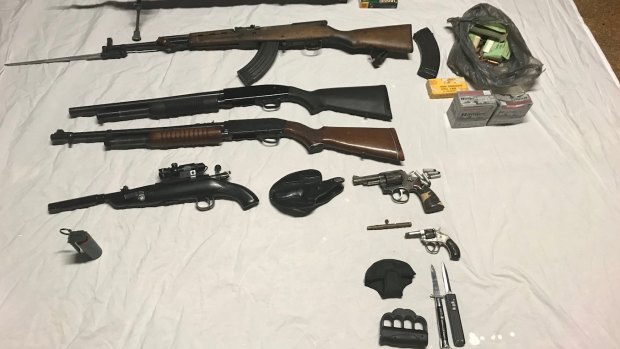 A cache of weapons was netted during the raid, according to police.
