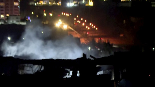 This image taken from video provided by Rudaw TV shows smoke rising from a building hit by a strike in Irbil, Iraq, on January 16.