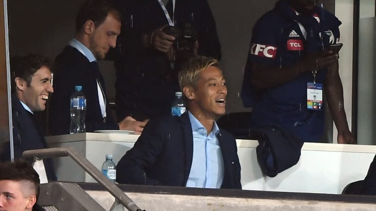 Keisuke Honda sits in the stands on Saturday night.