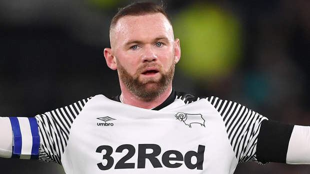 Wayne Rooney, with the club's sponsor emblazoned on his jersey, celebrates scoring for Derby County in the Sky Bet Championship.