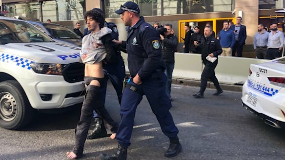 Mert Ney is arrested after being detained by members of public. 