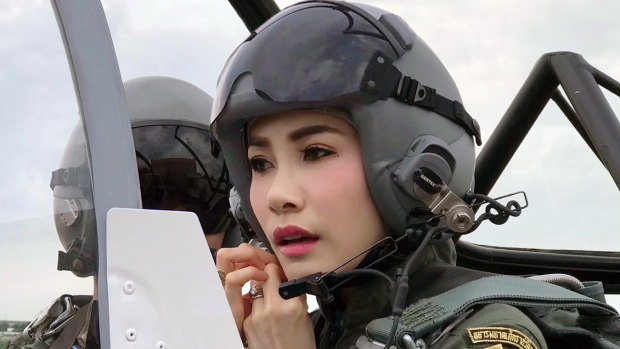 Thai Royal Noble Consort Sineenat Wongvajirapakdi adjusts her helmet in a military aircraft during training in Thailand.