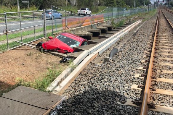 One of several vehicles in the rail corridor that were swept there by floodwaters.