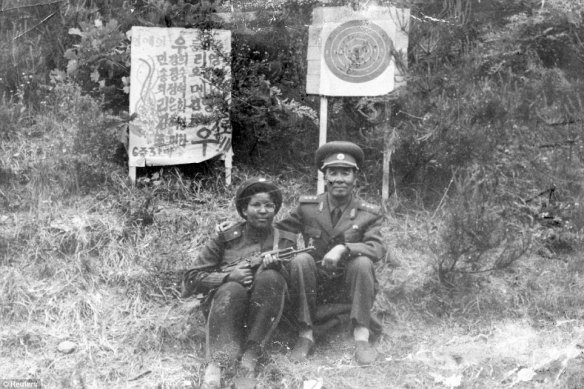 Macias with a school director during military training in North Korea. 
