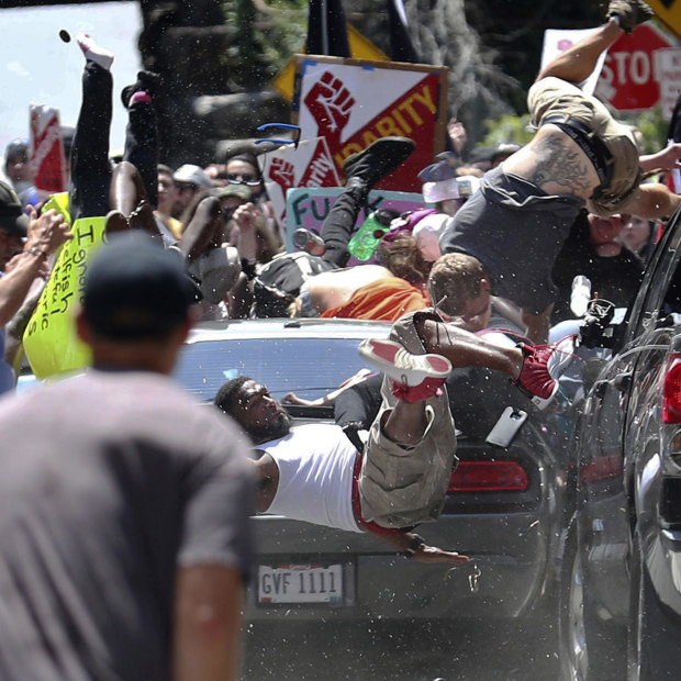 People fly into the air as a vehicle drives into a group of protesters demonstrating against a white nationalist rally in Charlottesville, Virginia.
