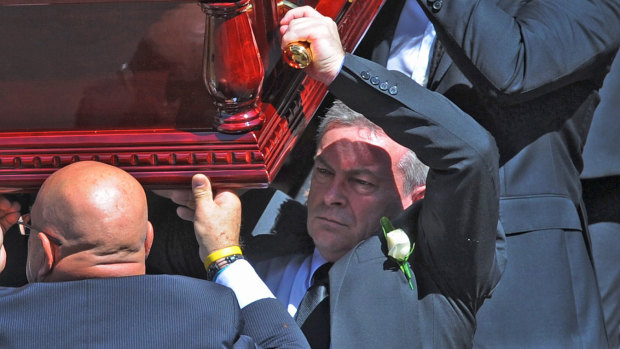 Borce Ristevski helps carry his wife's coffin at her funeral last year.