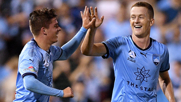 Dream come true: Cameron Devlin high-fives Brandon O'Neill for setting him up with his maiden A-League goal.