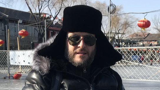 Beijingers skate on modified bikes and chairs on a frozen lake behind the Forbidden City.