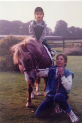 Francesca as a child being led by jockey Frankie Dettori.