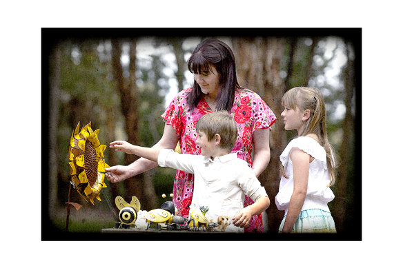 Georgie with Aaron and Elaina in their memorial garden for Tyson. 